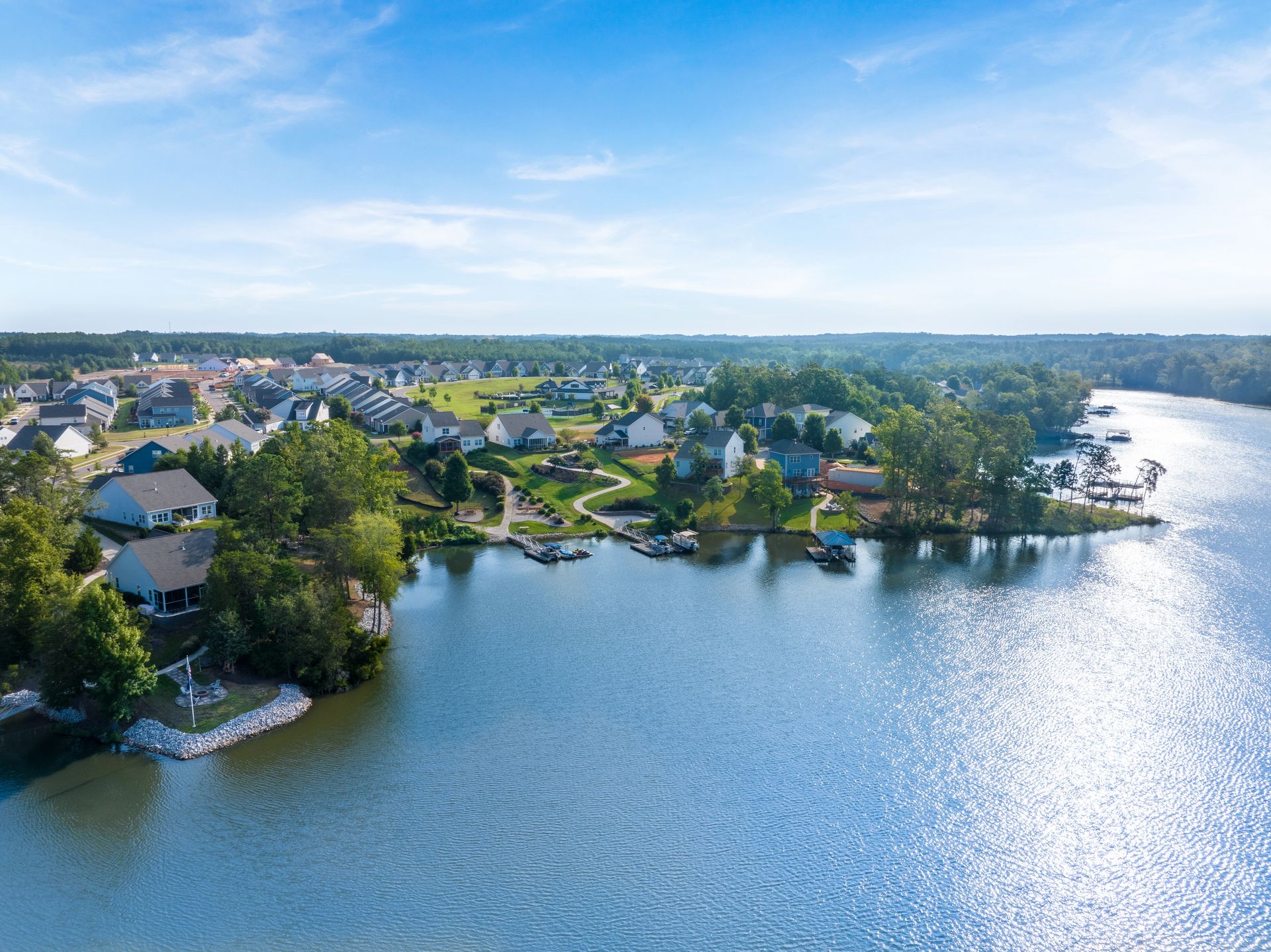 Aerial view of Fishing Creek Lake waterfront homes with private docks and boats